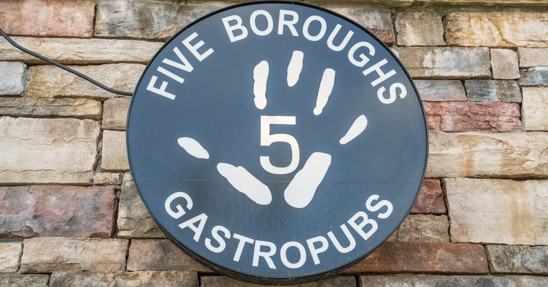 #exterior, round sign on the stone wall