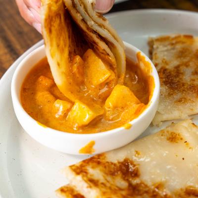 A cheesy curry dip served with flatbread.