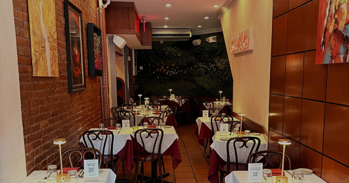 Dining area with set tables and wall art