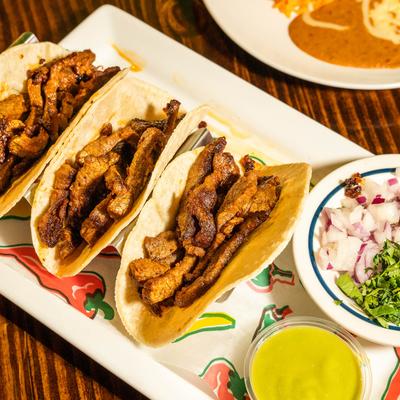 Carne asada tacos, served, top view, closeup.