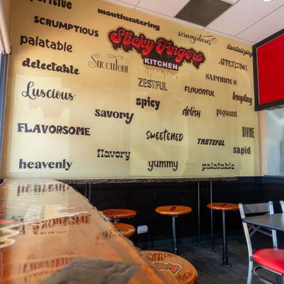 Interior with a wall mural with various adjectives describing food.