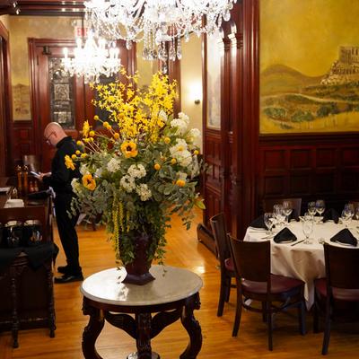 Interior space, charming dining room with floral display and quaint atmosphere.