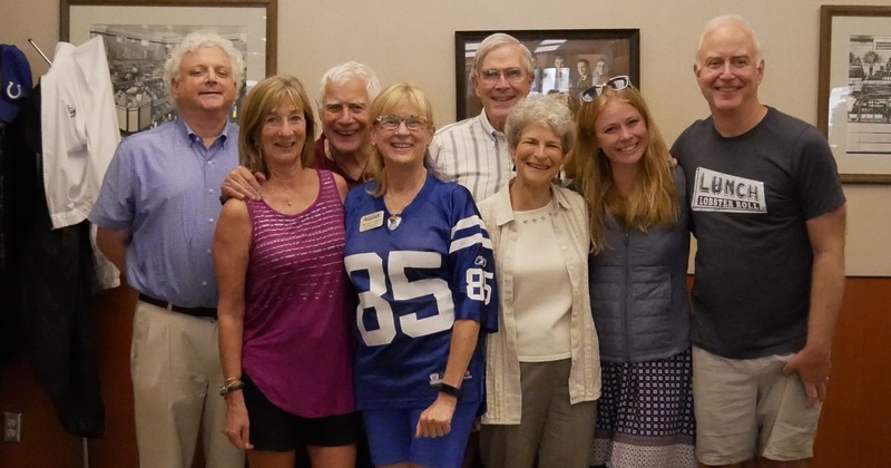 Guests standing, looking into the camera and smiling