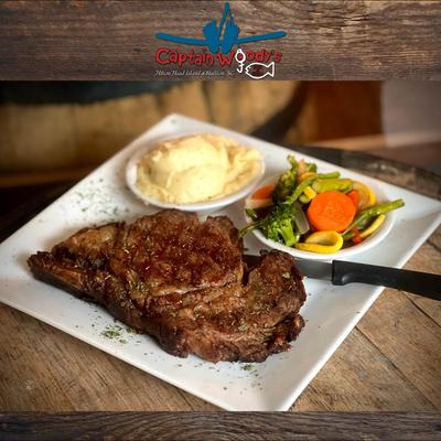 Prime Rib Eye Steak served with mashed potatoes and a vegetable salad.