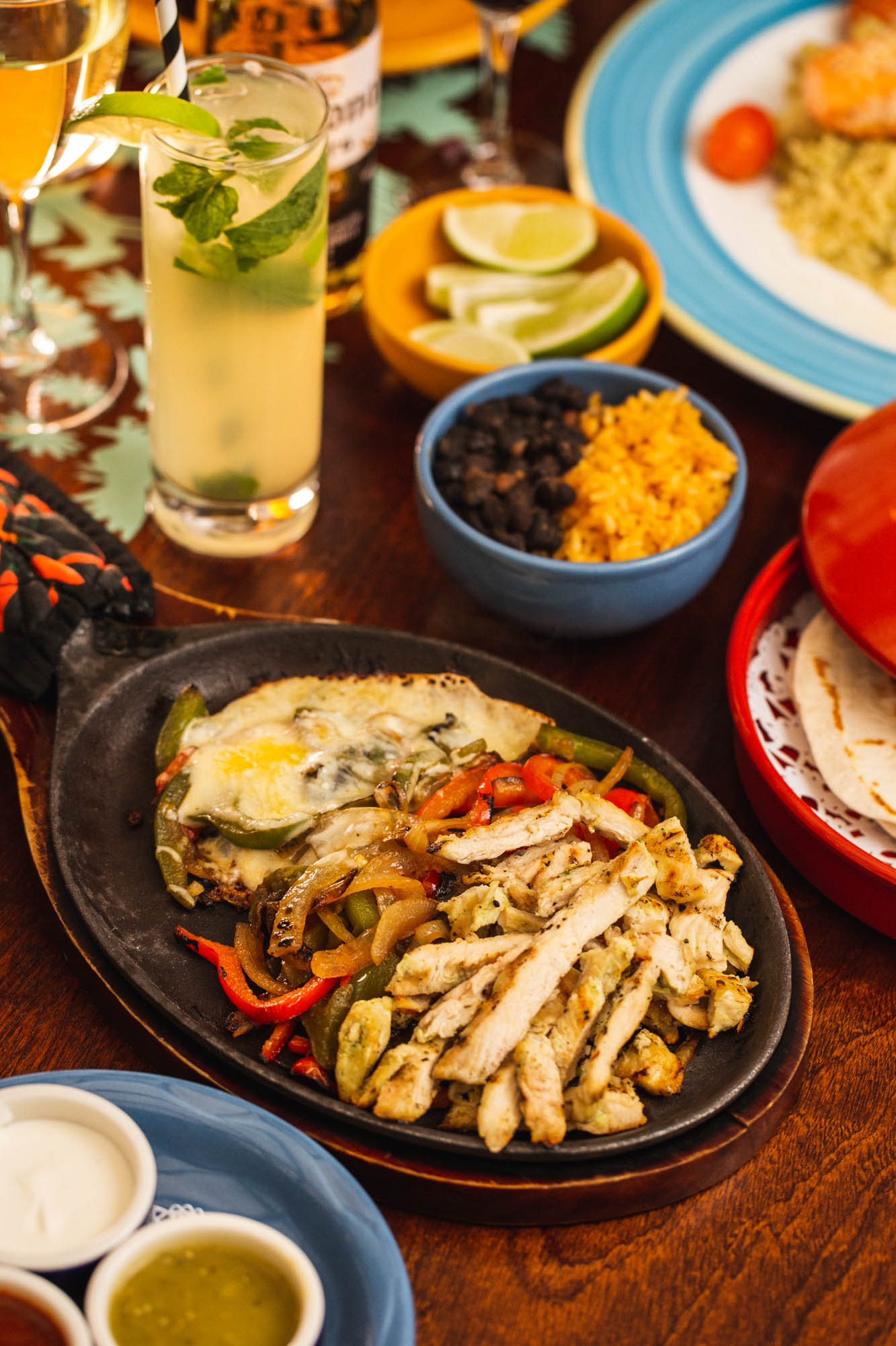 Chicken fajita plate, on the table with side dishes and drinks