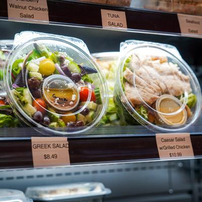 Assorted prepared meals in display case.