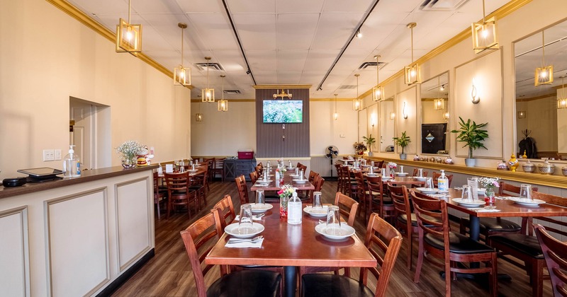 Interior of spacious and cozy dining area with set tables ready for guests