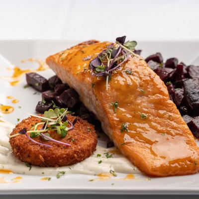 Pan Seared Salmon served with roasted beets, risotto cake and lemon aioli.
