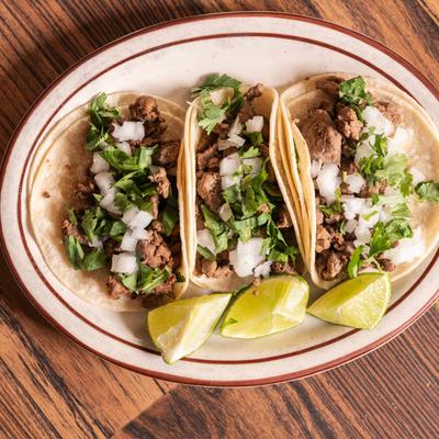 Beef tacos, with onion and cilantro.