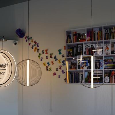 Interior, pendant lights, butterfly wall decal and a bookcase with books and magazines.