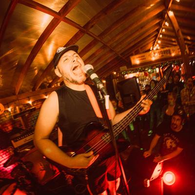 A bassist singing on stage