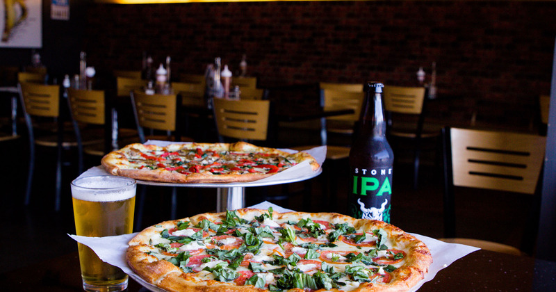 Pizzas and beer on a table in dining are