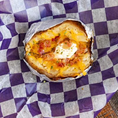 Loaded Baked Potato Topped with Butter, Sour Cream, Bacon Bits, and Shredded Cheddar.