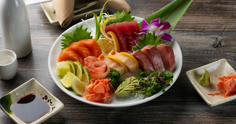 Sashimi combo platter with assorted fish, condiments and garnishes
