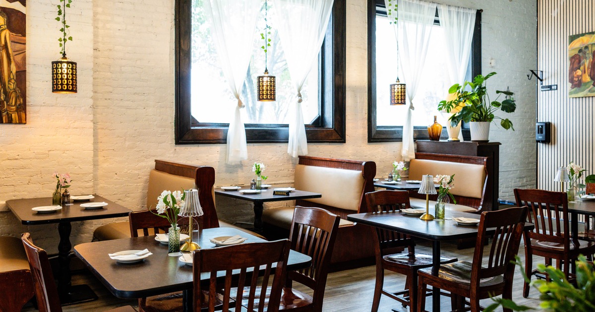 Interior seating area with wooden tables and dark chairs