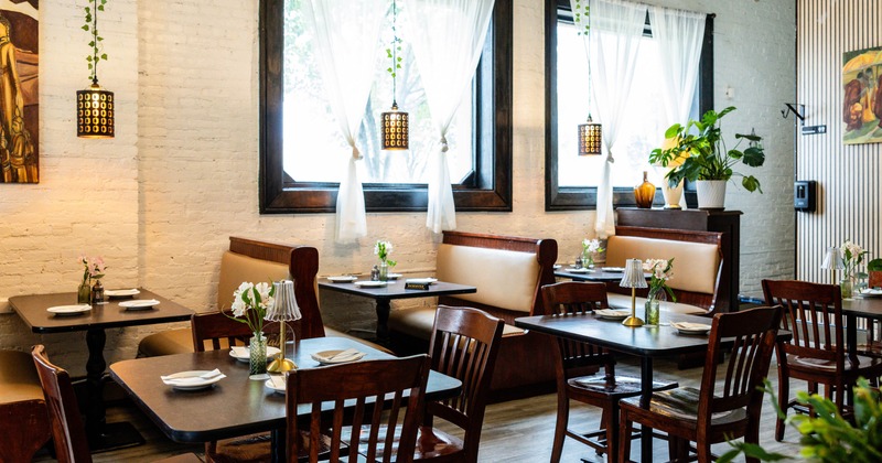 Interior seating area with wooden tables and dark chairs