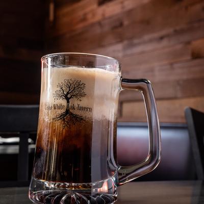 Root beer float served in a branded glass mug.