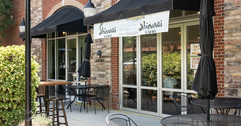 Outdoor seating area of a brick restaurant