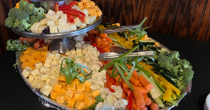 Various cheeses and vegetables on tray