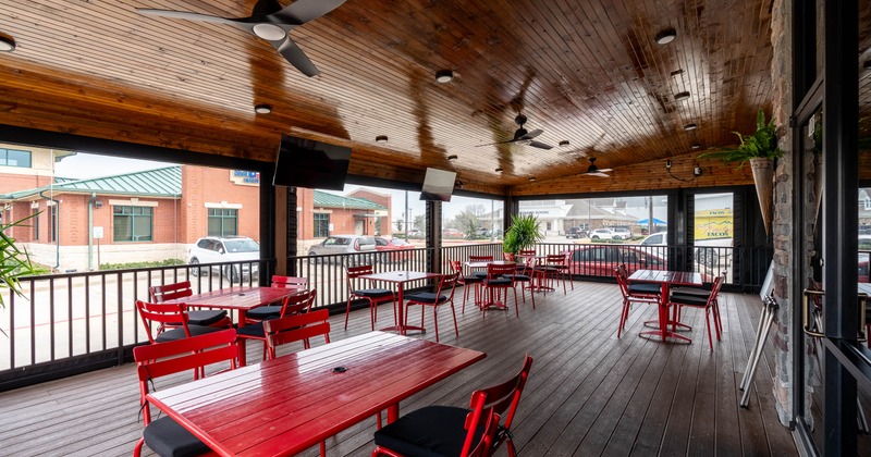 Interior, seating area with red tables and chairs