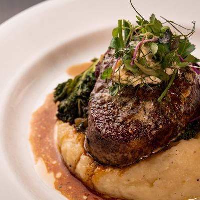 Filet Mignon on a bed of mashed potatoes.