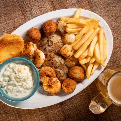 Key West Gulf Combo, with grilled hog snapper fish, scallops, shrimp, slaw, and fries.