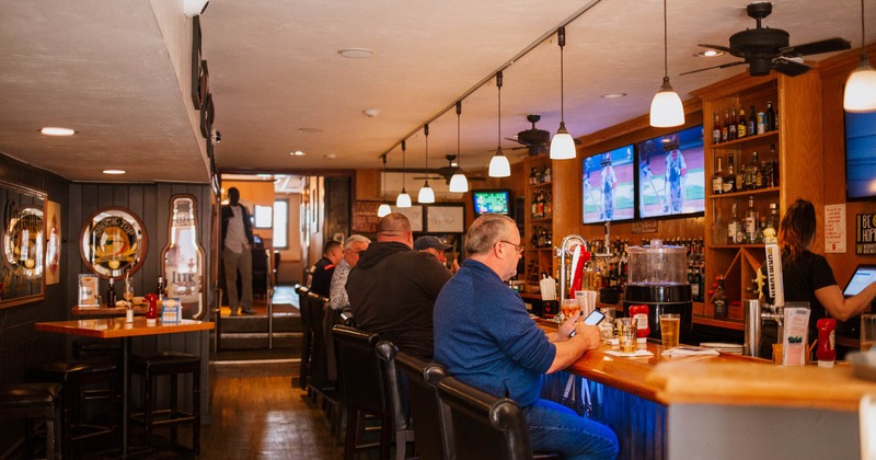 Interior, guests sitting at the bar