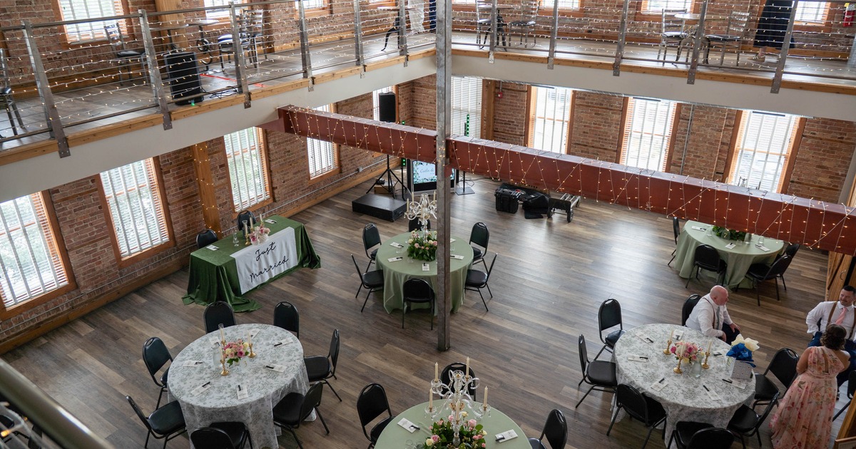 Industrial-style interior featuring exposed brick walls and a mezzanine level