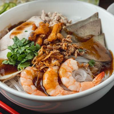 Noodle bowl with shrimp, pork, pork loaf and herbs.