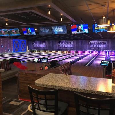 The bowling area, tables and chairs.
