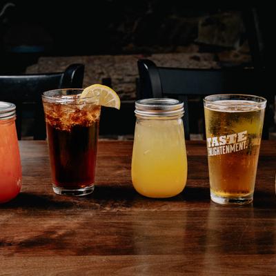Assorted drinks lined up on a table.