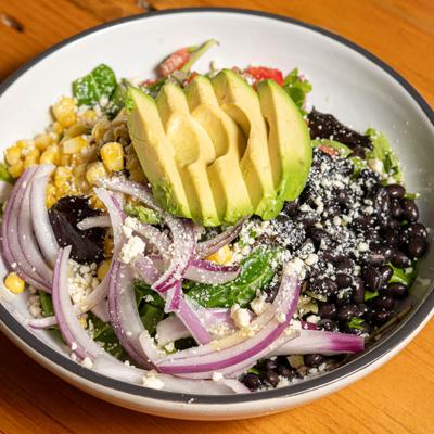 Fiesta Salad with corn, black beans, pico de gallo, avocado and cotija cheese.