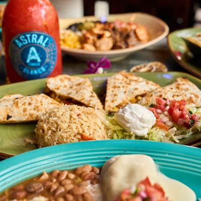 Santa Fe Quesadilla plate on a table surrounded by various food plates.