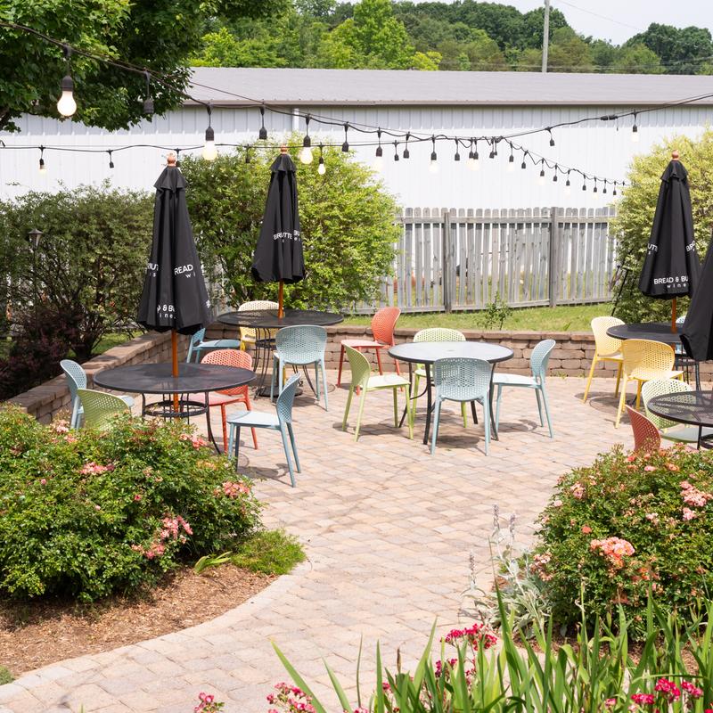 patio seating area with flowering bush nearby