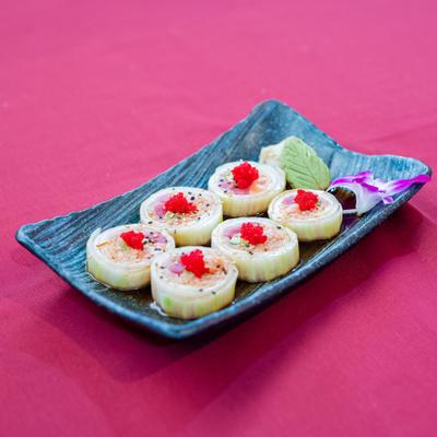 Naruto Roll with tuna, salmon, yellowtail, avocado, and tobiko, wrapped in cucumber.