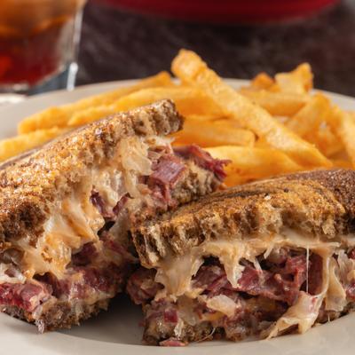 Reuben sandwich with side of fries.