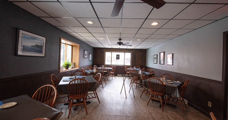 Interior, tables and chairs, framed photos on the wall