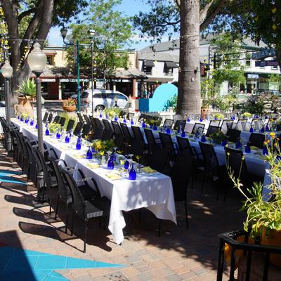 Exterior, dining area, fully set joined tables.