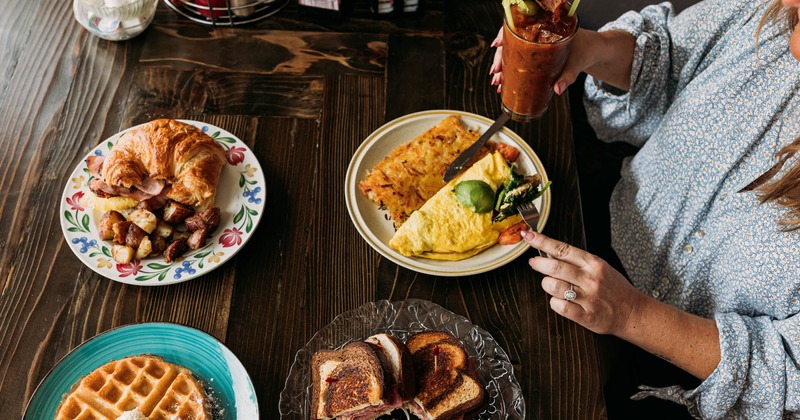 Interior, guests dining, top view of of the table with served dishes