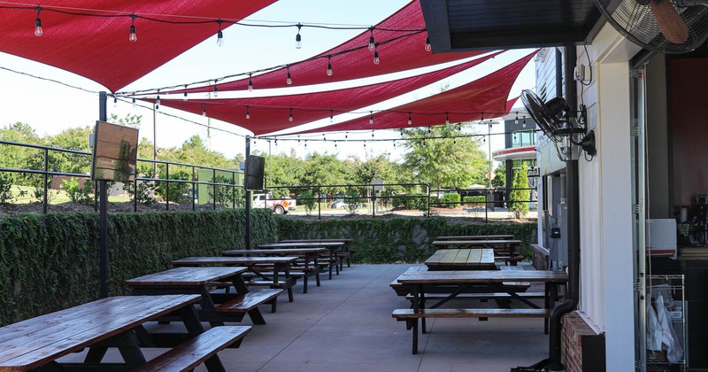 Outside seating area covered with sun shade sails