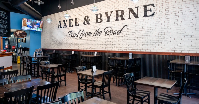 Diner area, tables and chairs, logo banner above