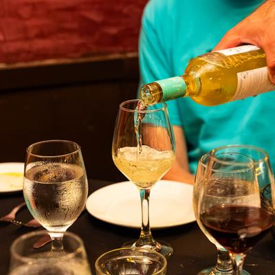 Pouring a glass of white wine.