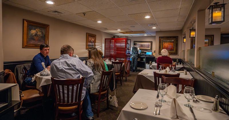 Restaurant interior, dining area with set tables and guests