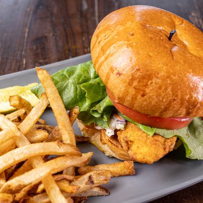 Served catfish sandwich with fries.