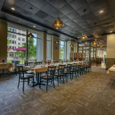 A very long dining table and chairs.