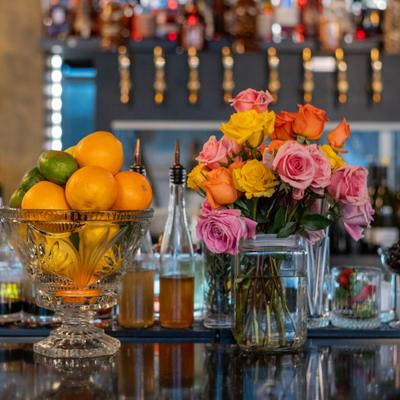 Bowls of fruits and flowers displayed on the bar.
