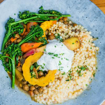 Fregola pasta with chickpeas, vegetables, and dill yogurt.