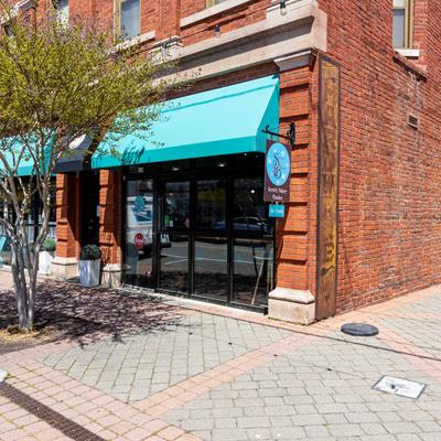 The entrance to the bakery and the sidewalk outside.