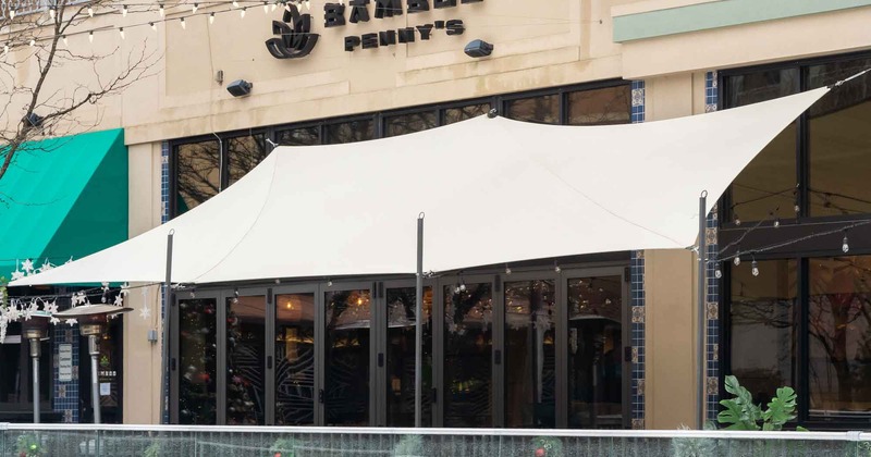 Exterior, entrance to a restaurant, a  shade curtain above, sign