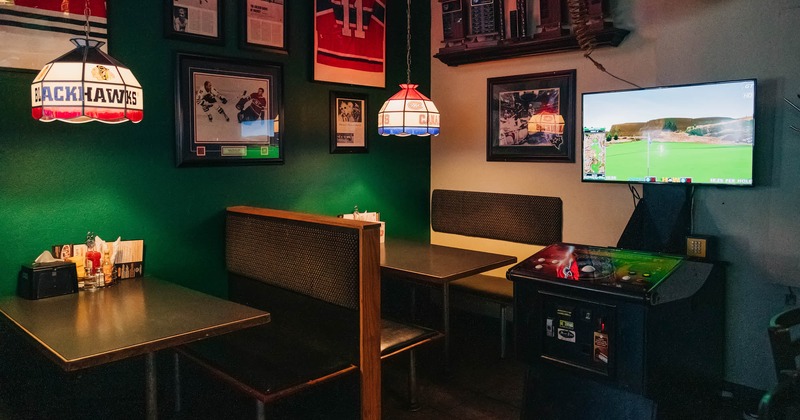 Interior, sitting booths and tables, tv screen on the wall